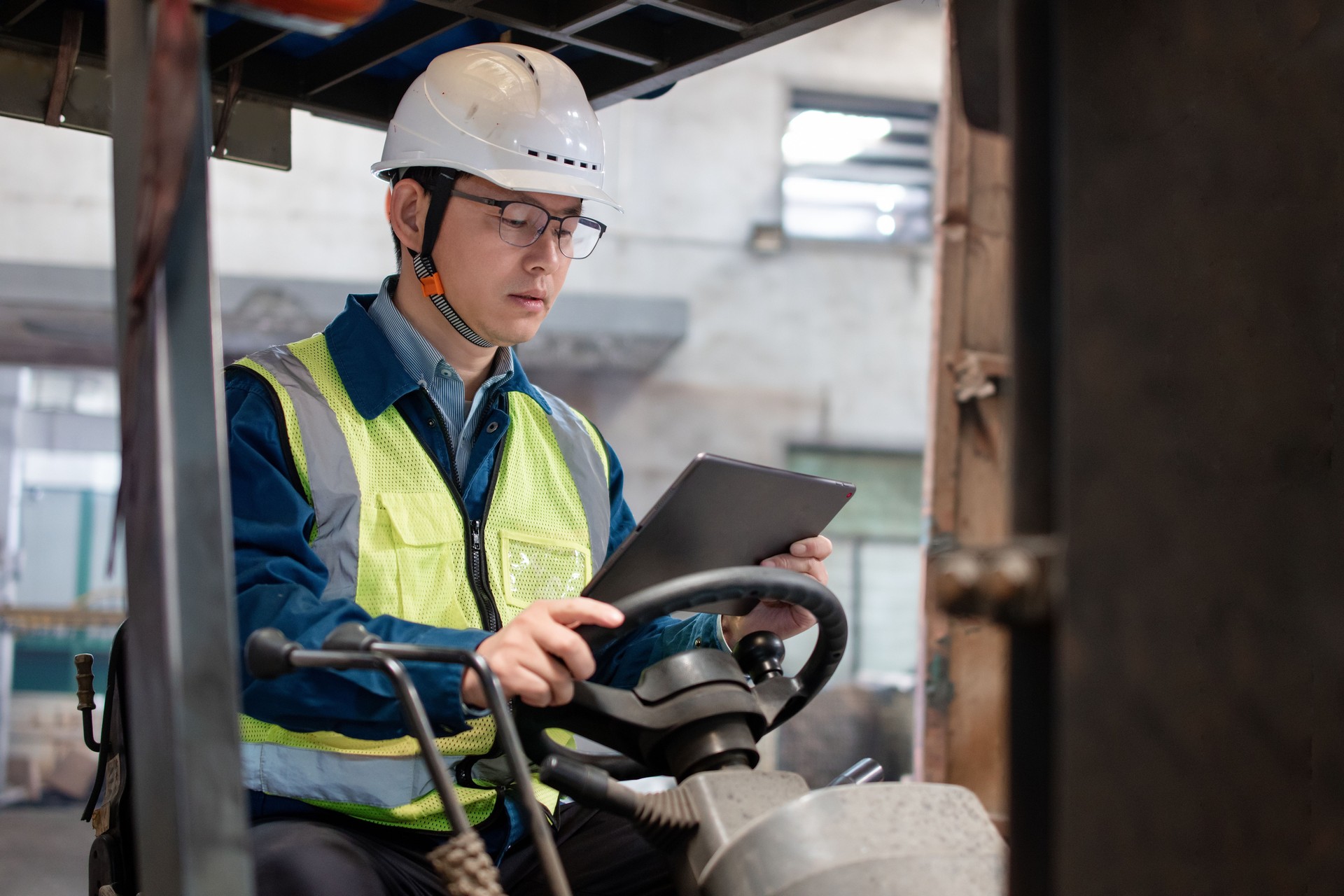 Asian male workers are using tablet computers to handle shipments in the warehouse