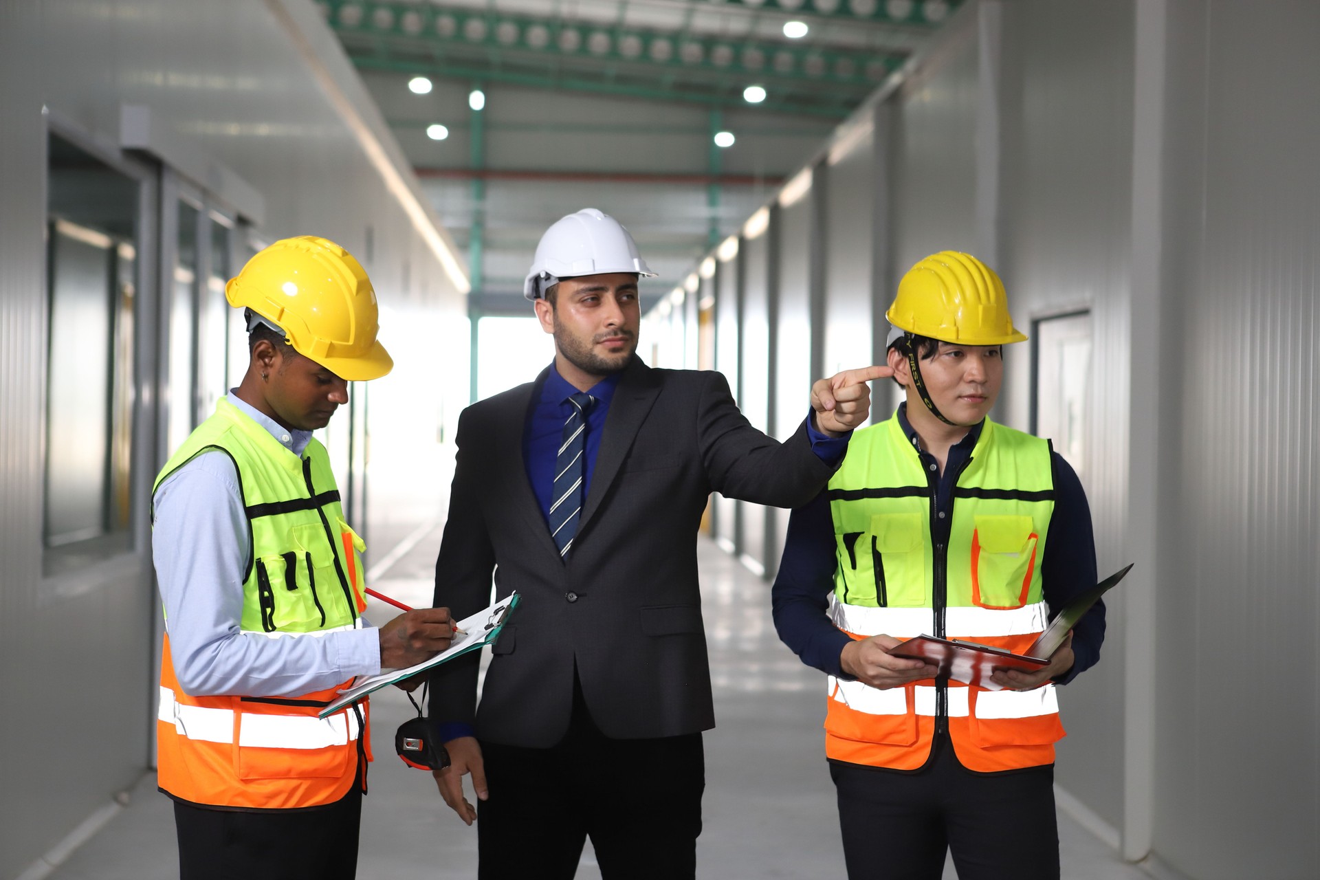 worker or engineer working in factory with safety uniform , safety hat and safety glasses , image is safety concept or happy workplace